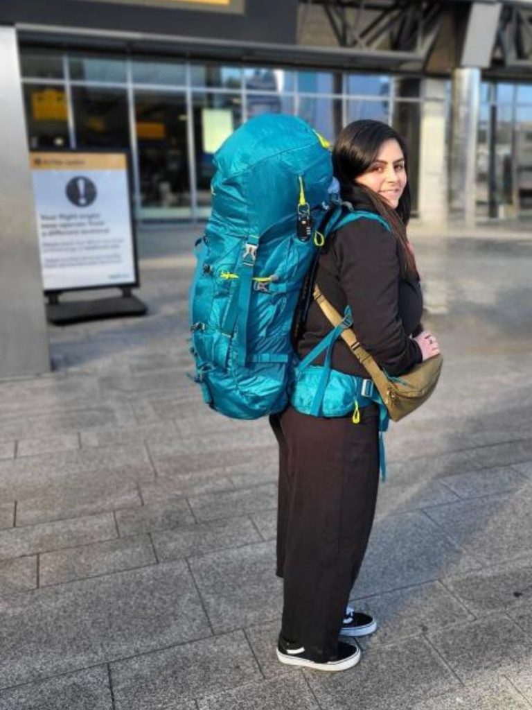 Woman wearing backpack at airport
